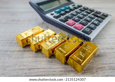 gold bars with calculator . Financial savings concept.