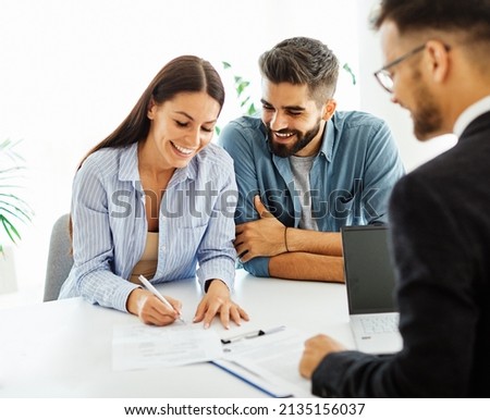 Real estate agent with couple closing a deal and signing a contract Royalty-Free Stock Photo #2135156037