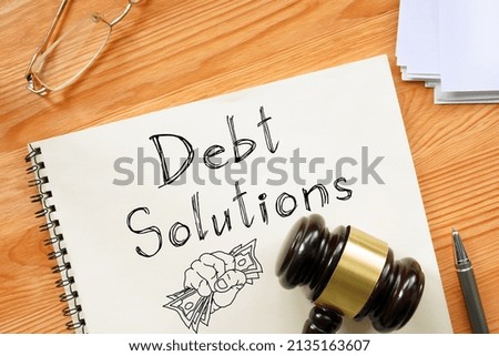 Debt solutions are shown on a business photo using the text