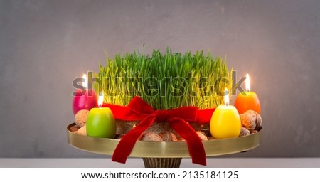 Beautiful Novruz tray with semeni - wheat grass, pakhlava, shekerbura and festive candles for Spring equinox and new year celebration in Baku.