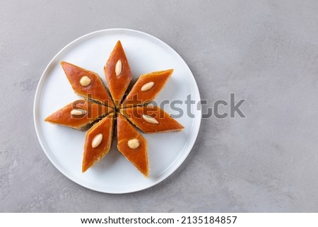 Plates with Azerbaijani national pastries for Novruz - pakhlava and shekerbura on light grey background for Novruz celebration, spring equinox and new year celebration in March.