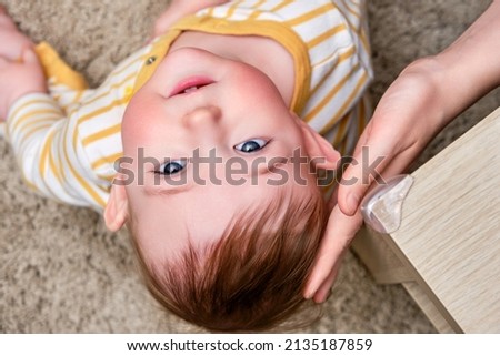 Danger for baby hit the corner of the table. Protect children from home furniture, kids safety Royalty-Free Stock Photo #2135187859