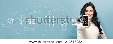 Business growth analysis with young woman holding out a smartphone in her hand