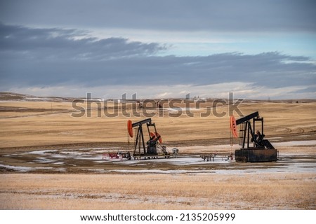 Pump jacks working in the oilfields of Alberta, Canada.