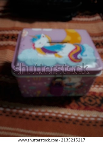 defocused abstract background The pink child's savings holder has a picture of a horse at the top. very beautiful