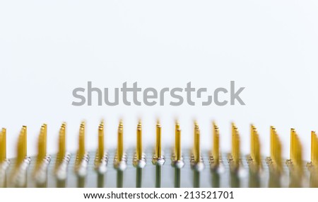 Detailed shot of computer CPU pins which are being widely recycled for their valuable gold content. Recycling banner concept. Great for background