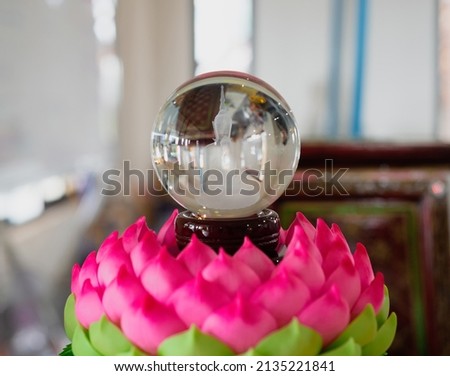 The glass ball has a Buddha image inside. on the pink lotus Wat Phasorn Kaew, Phetchabun Province