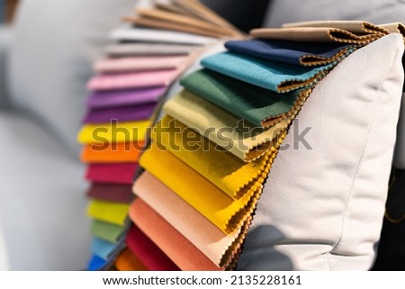 Tissue catalog. Catalog of multi-colored fabric samples. Textile industry background. Colored cotton fabric. Tissue catalog. Selects the color of the sofa. Textile industry background. Palet