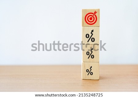 stack of wooden cube block with red dartboard on top for profit, increase revenue, completed target concept