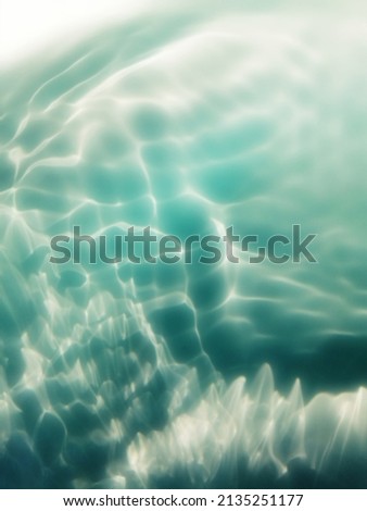 Closeup​ abstract​ of​ surface​ blue​ water​ in​ the​ deep​ sea​ for​ background. The​ pattern​ of​ blue​ water​ for​ background. Abstract​ of​ surface​ blue​ water. Water​ splash​ed​ for​ background​