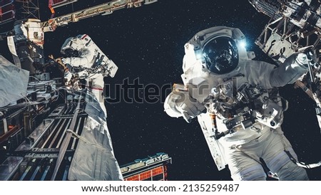 Astronaut spaceman do spacewalk while working for spaceflight mission at space station . Astronaut wear full spacesuit for operation . Elements of this image furnished by NASA space astronaut photos . Royalty-Free Stock Photo #2135259487
