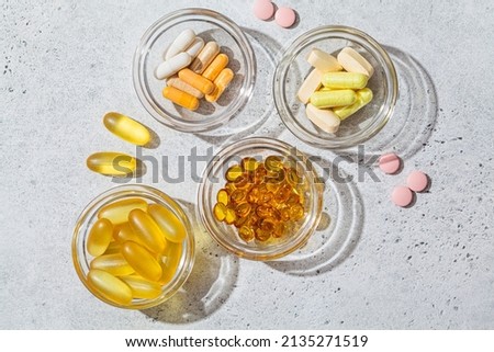 Flat lay of different types of tablets, pills, capsules and vitamins. Daily dose of supplements for health. Royalty-Free Stock Photo #2135271519