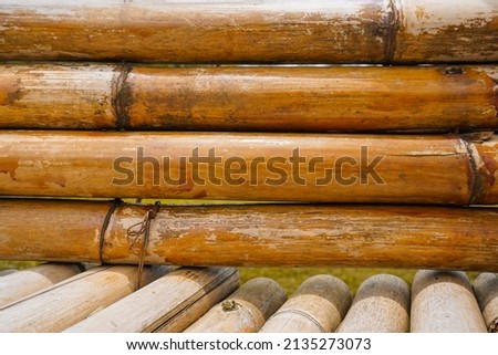 Dried bamboo is neatly lined up to be used as a suspension bridge in natural attractions