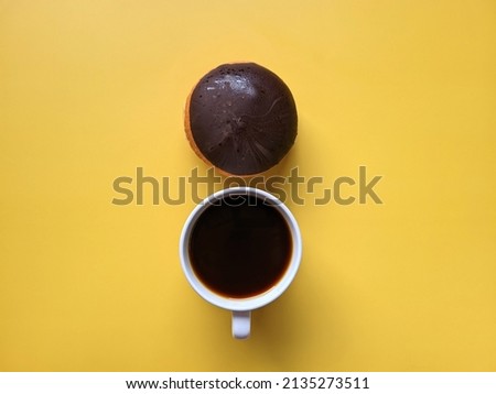 Morning with cup of hot coffee and sweet donuts on yellow background. Top view, copy space, mockup. Flat lay. Food and drinks. Spring holidays. 