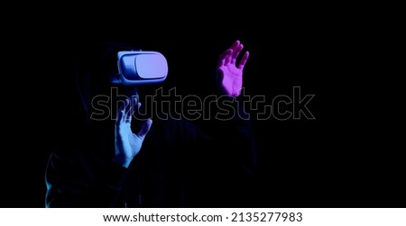 Vr goggles virtual reality. Young man in digital helmet for 3d virtual reality game isolated on black neon background. Study and virtual world in 3D simulation