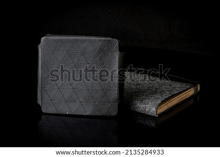 Close Up Classic dark brown leather wallet on black dark leather background