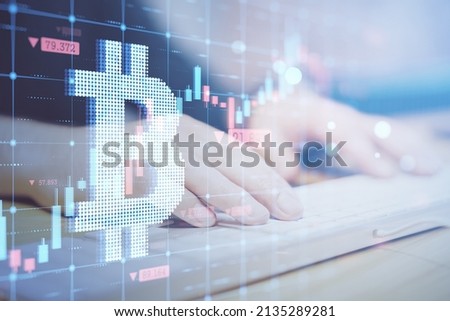 Close up of hands using computer keyboard with creative glowing bitcoin grid hologram on blurry background. Cryptocurrency and growth concept. Double exposure