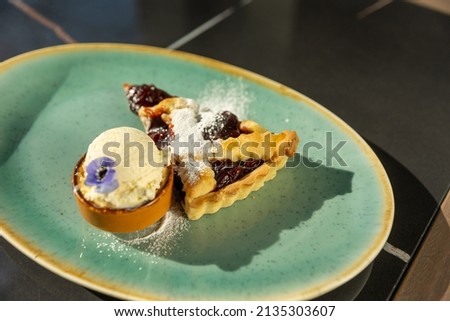 Cherry pie served with vanilla ice cream