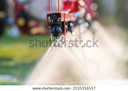 Nozzle of the tractor sprinklers sprayed. Royalty-Free Stock Photo #2135316517