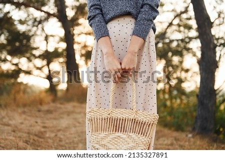 Young woman have a walk outdoors in the forest at sunny daytime.