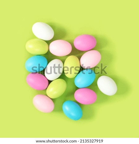 Multicolored painted Easter eggs on green paper background. Flat lay  top view with copy space. Banner for congratulations. 

Concept design. 