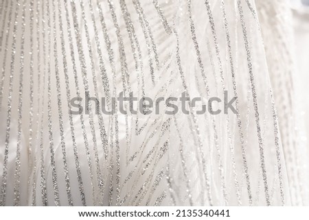 thin chiffon fabric with applied rhinestones. Tulle for light dresses and curtain interior. Elegant fashionable element of clothing Royalty-Free Stock Photo #2135340441