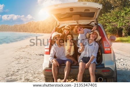 Group of happy Asian family fun travel on road trip in vacation at beach. Father, mother, daughter, son with enjoying on hatchback in seaside in summer holiday. Dad, mom, child tourism by auto journey Royalty-Free Stock Photo #2135347401