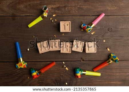 date April 1. Creative concept for April Fools' Day. Wooden letters April 1st and festive decor on the wooden background.