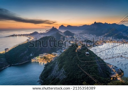 Rio de Janeiro cityscape with famous Sugarloaf Cable Car at sunset in Rio de Janeiro, Brazil.