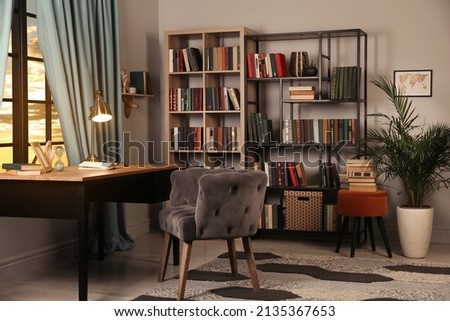 Cozy home library interior with collection of different books on shelves