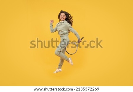 happy energetic kid jump in sportswear with squash racquet running to success, stamina. Royalty-Free Stock Photo #2135372269