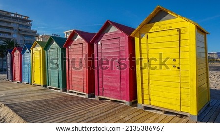 brightly colored wooden beach huts on the sand