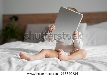 Caucasian little girl with digital tablet at home 