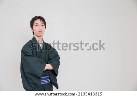 A man wearing a kimono with his arms folded Royalty-Free Stock Photo #2135413315