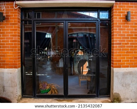 Outdoor mock up of store and shop front template - front view vintage black grey shop tone with windows display, close sign and orange brick wall.