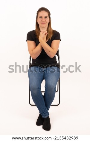 A young woman crosses her hands and feet and then puts her fingers together and feet together. This is an exercise from the Touch for Health called Wayne Cook. Isolated with white background.