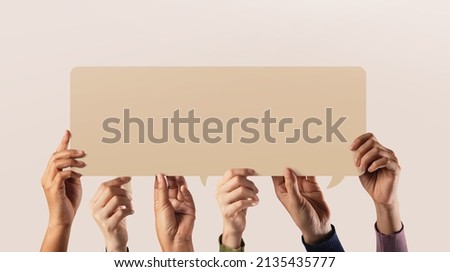 Peaceful, Human Rights and Freedom to Speak and Expression. Group of People Raised up a Blank Speech Bubble Card Royalty-Free Stock Photo #2135435777
