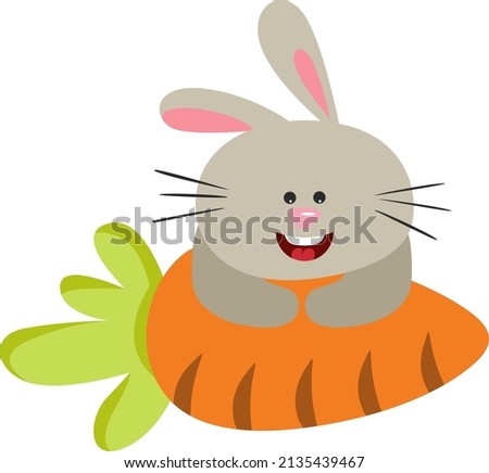 Funny bunny peeking out of a big carrot

