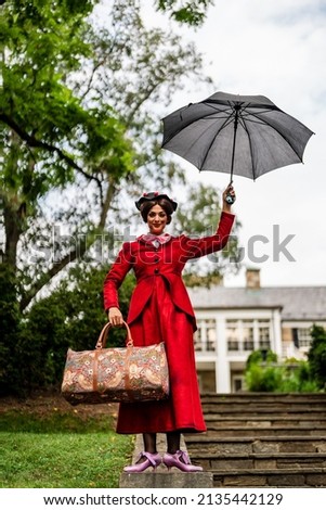 A movie Mary Poppins has been recreated. This photoshoot was designed to recreate the vide and the customs were made by the model. Royalty-Free Stock Photo #2135442129