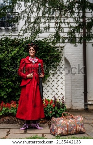 A movie Mary Poppins has been recreated. This photoshoot was designed to recreate the vide and the customs were made by the model. Royalty-Free Stock Photo #2135442133