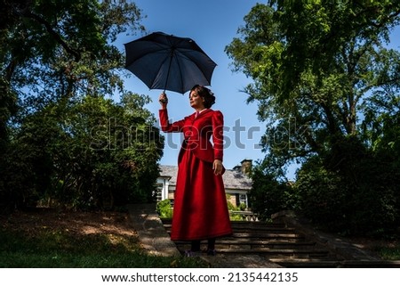 A movie Mary Poppins has been recreated. This photoshoot was designed to recreate the vide and the customs were made by the model. Royalty-Free Stock Photo #2135442135