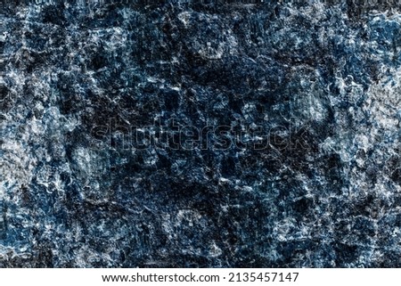 Abstract rough textured dark blue color old stone wall surface for background