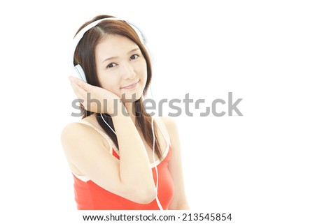 Attractive young Asian woman listening to music. 