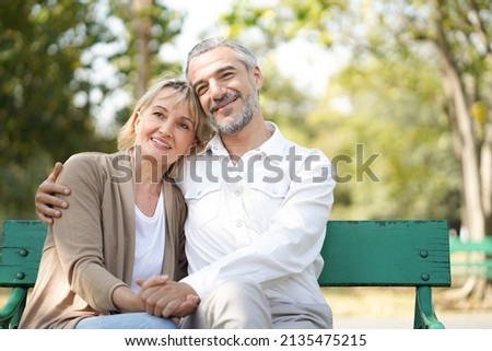 Portrait of happy elderly couple hug together, take care and love with good relationship, good health and romantic in the park, retirement insurance and lovely couple concept Royalty-Free Stock Photo #2135475215