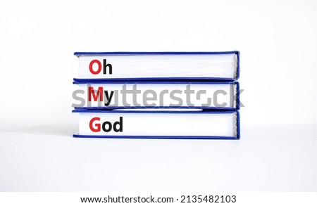 OMG oh my god symbol. Concept words OMG oh my god on books on a beautiful white table, white background. Business and OMG oh my god concept. Copy space.