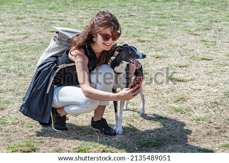 Happy beautiful girl taking selfie with her dog