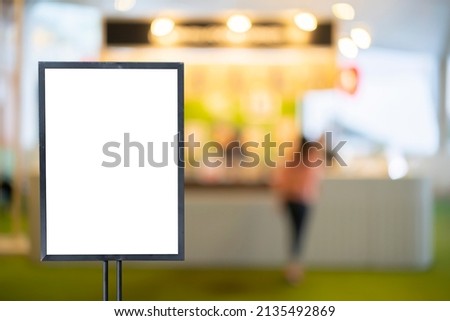 mockup white poster with black frame stand in front of blur restaurant cafe background for show or present promotion product concept