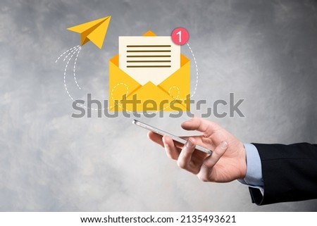 Businessman hand holding e-mail icon, Contact us by newsletter email and protect your personal information from spam mail. Customer service call center contact us concept.