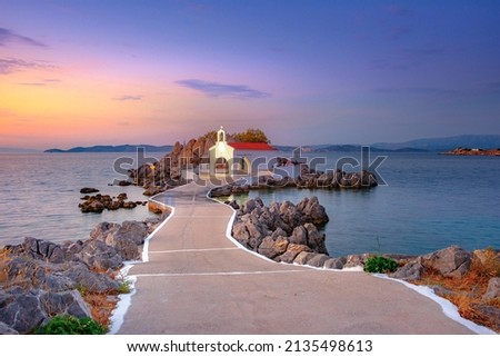 Little church of Agios Isidoros in the sea over the rocks, Chios island, Greece. Royalty-Free Stock Photo #2135498613