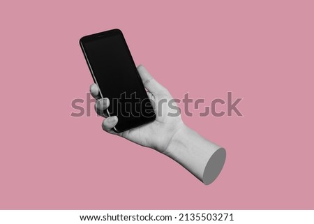 Mobile phone with black screen in female hand isolated on a pink color background. Blank with an empty copy space for the text. Trendy collage in magazine urban style. Contemporary art. Modern design Royalty-Free Stock Photo #2135503271